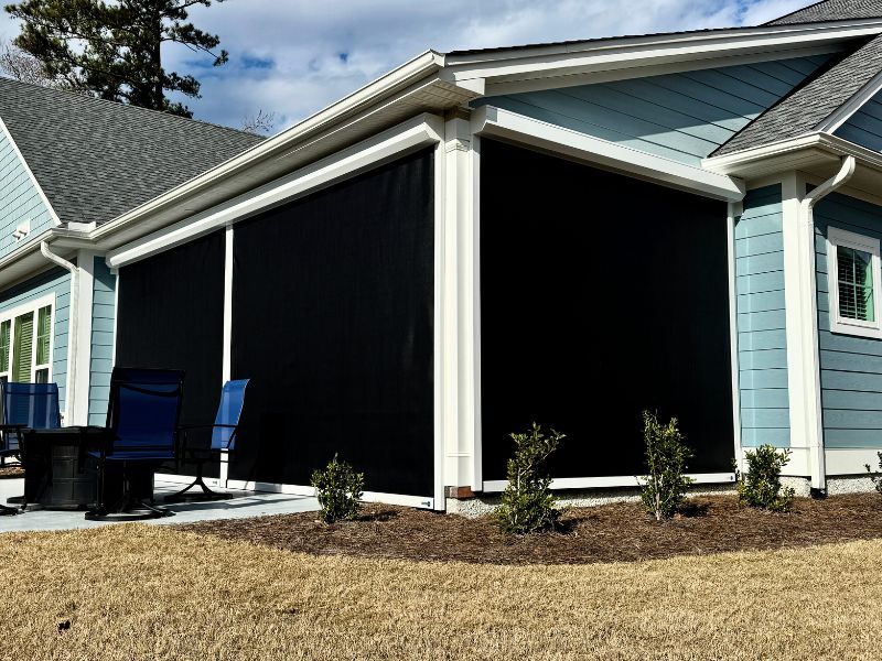 blue house in Wilmington NC protected with hurricane shutters and hurricane screens