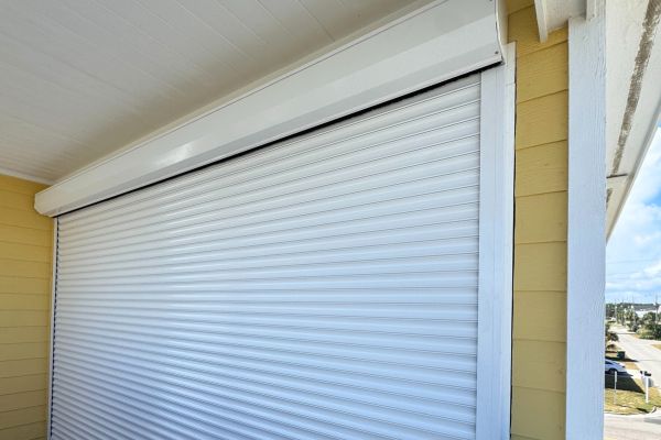 white roll down hurricane shutters on balcony 